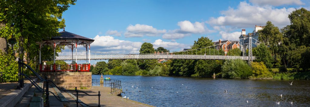 beautiful panoramic view of the River Dee and the Dee Suspension Bridge in the historic city of Chester in Cheshire, UK.
