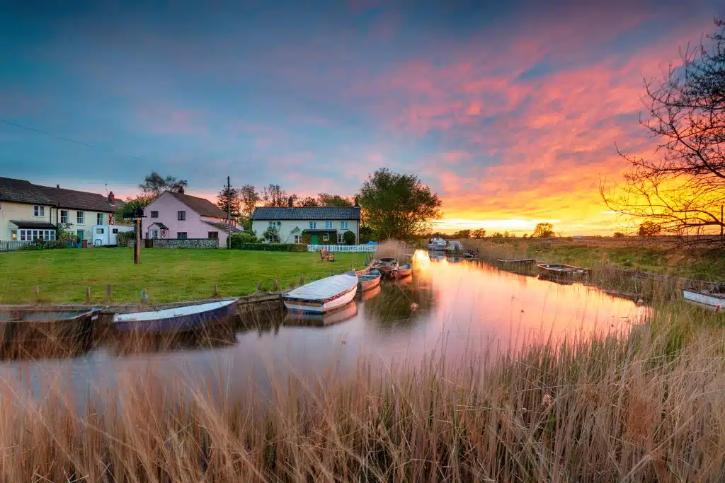 Stunning sunset over the village green and boats on the river at West Somerton