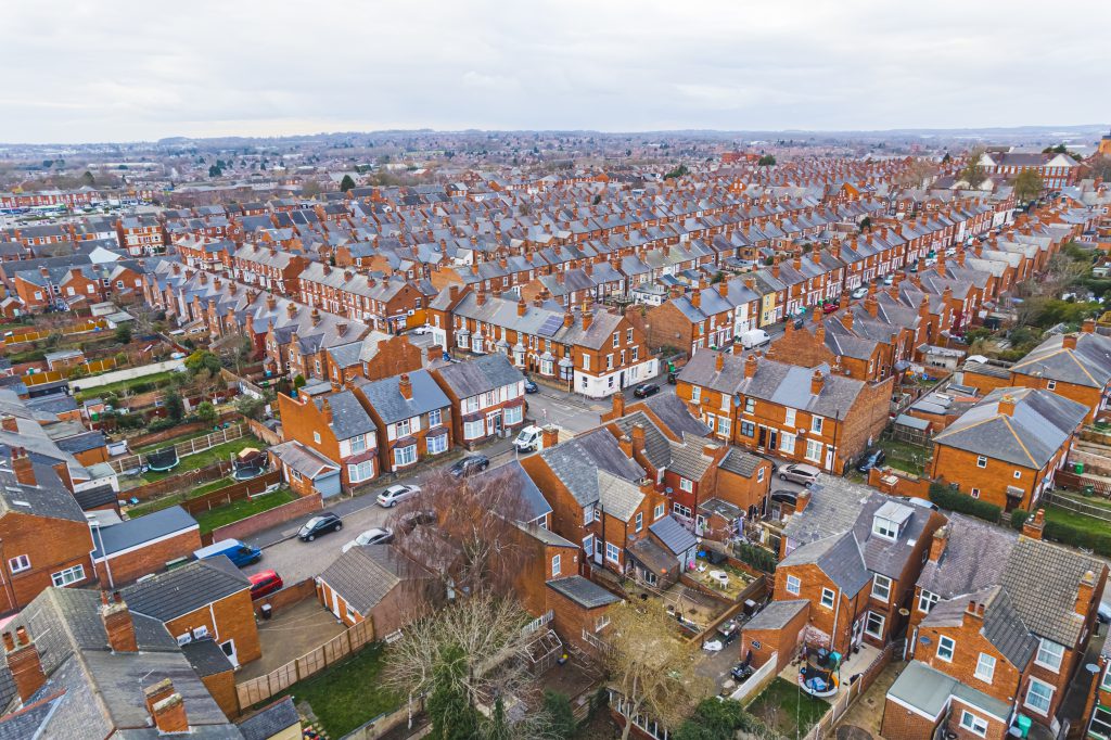 scenic drone shot of orange houses with grey rooftops, Wollaton suburb, Nottingham, United Kingdom